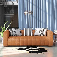 a living room filled with furniture next to a spiral staircase