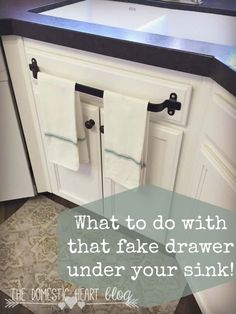 a kitchen sink with two towels hanging on the cabinet doors and a quote that reads, what to do with that fake drawer under your sink