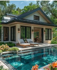 a house with a pool in front of it and some flowers around the pool area