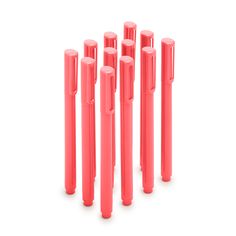 six pink plastic pens lined up in a row