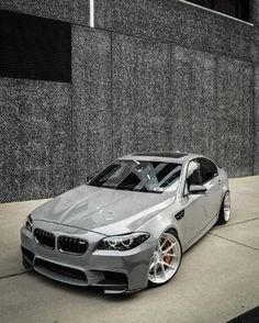 a silver car parked in front of a building