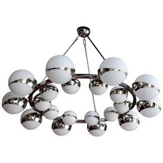 a large chandelier with white glass balls hanging from it's center point