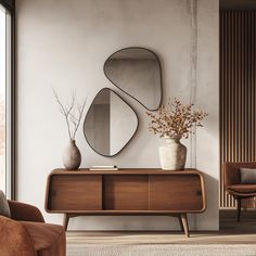 a living room with a large mirror on the wall next to a wooden cabinet and chair