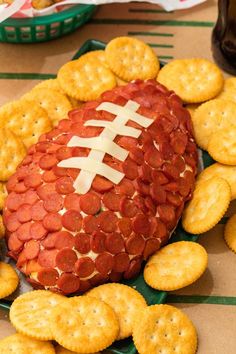 a football shaped cheese ball surrounded by crackers