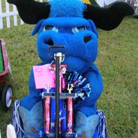 a stuffed animal riding on the back of a wagon filled with candy and candies