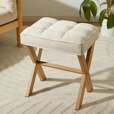 a white bench sitting on top of a rug