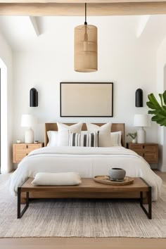 a bedroom with a bed, nightstands and plants on the side table in front of it