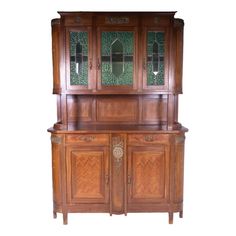 a wooden cabinet with glass doors and drawers