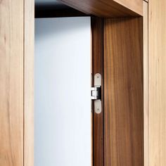 an open wooden door with white glass in it