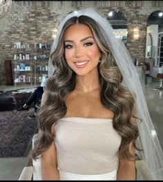 a woman with long hair wearing a wedding veil