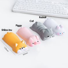 three little animals sitting on top of a white desk next to a keyboard and mouse