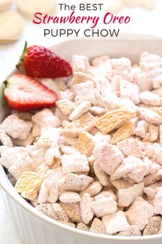 a bowl filled with puppy chow next to a strawberries and strawberry on the side