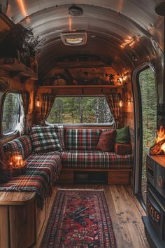 the inside of an rv with couches, rugs and fire place in it