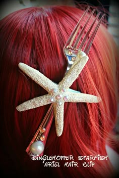 a close up of a person with red hair and a starfish comb on their head