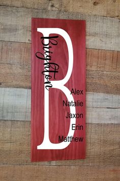 a wooden sign with the letter b in white ink on red wood planks that reads, personalized