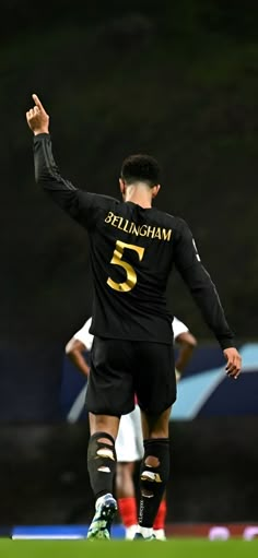 the soccer player is getting ready to kick the ball in his team's game