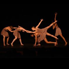 the dancers are performing on stage with their arms in the air