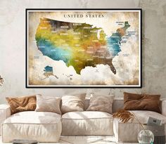 a map of the united states on a wall above a couch in a living room