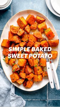 a white plate topped with sweet potatoes on top of a blue tile floor next to two plates