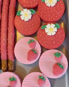 strawberry cupcakes and strawberries are arranged on a tray