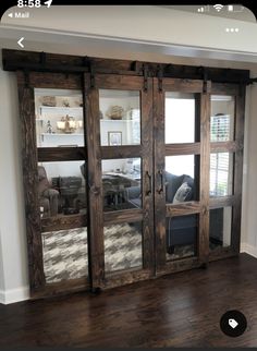 a living room with wooden floors and sliding glass doors