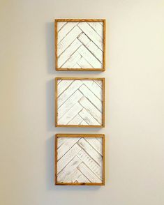 three mirrors mounted to the side of a wall