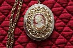 This vintage locket has a very pretty cameo.   It measures  46 mm x 38 mm.        I put this gorgeous locket on  a wonderful 22 1/8 inch gold plated  vintage rope chain.  I added a gold plated bail to the cameo and a gold plated toggle to finish the necklace.  This locket has a little wear on the back, but otherwise is in great vintage condition.  The chain is also in excellent vintage condition.  Together they make a beautiful necklace.   This necklace would make a lovely gift for any woman who wants to carry the photos of her loved ones next to her heart. Thank you for taking time out of your day to visit  KeepGrandmaBusy.  If you have any questions, please contact me through the etsy convo system. Evette Rice Vintage Locket, Vintage Lockets, Beautiful Necklace, Locket Necklace, Time Out, Rope Chain, Gift Christmas, Woman Face, Mother's Day Gift