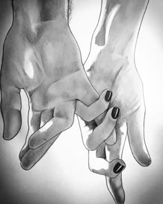 two hands holding each other with black and white ink on paper in front of them