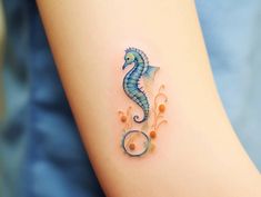 a sea horse tattoo on the arm