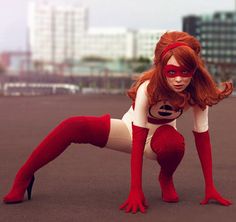 a woman dressed in red and white poses for the camera with her legs spread out