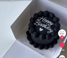 a black birthday cake in a white box with the words happy birthday written on it