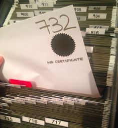 a person holding a stack of files with the number 123 on it in front of them