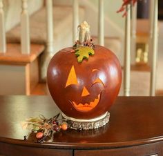 a carved pumpkin sitting on top of a wooden table