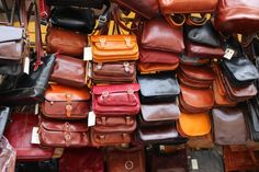 many different types of purses on display for sale