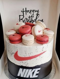 a birthday cake with macaroons and happy birthday written on it