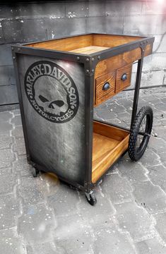 a wooden cart with wheels and an emblem on it