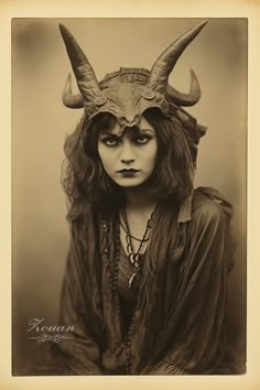 an old photo of a woman with horns on her head and long hair, wearing a costume