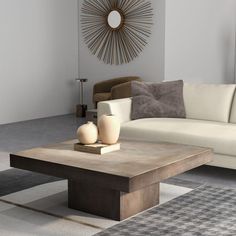 a living room with a couch, coffee table and rug in front of the wall