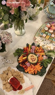 a table topped with lots of different types of food and desserts on top of plates