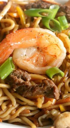 noodles with shrimp and vegetables in a white bowl