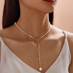 This Faux Pearl Ribbon Box Y Liars Necklace Is A Wonderful Addition To Your Wardrobe And Your Style! A Fun And Unique Piece Sure To Get Lots Of Compliments! Silhouette Necklace, Abstract Pendant, Pearl Bow, Sunflower Necklace, Pearl Decor, Layered Necklace Set, Bow Decor, Bow Necklace, Metal Detail