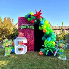 an inflatable tmnt balloon arch with the letter b and some decorations