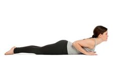 a woman is doing yoga on her stomach