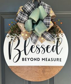 a wooden sign that says,'blessed beyond measure'with a bow on it