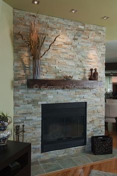 a living room with a fire place and a vase on the mantel above it