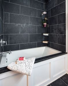 a black and white tiled bathroom with a bathtub