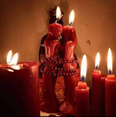 candles are lit in front of a mirror