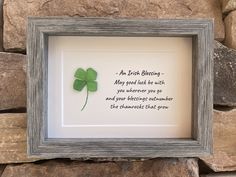 a wooden frame with a four leaf clover on it and a poem written in cursive writing