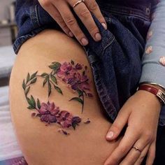 a woman's thigh with flowers on it