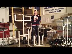 a man standing next to some metal pipes in a room filled with boxes and other items